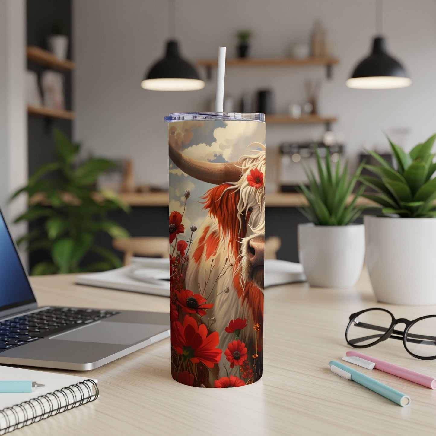 Highland cow illustration with red poppies on a patterned tumbler.