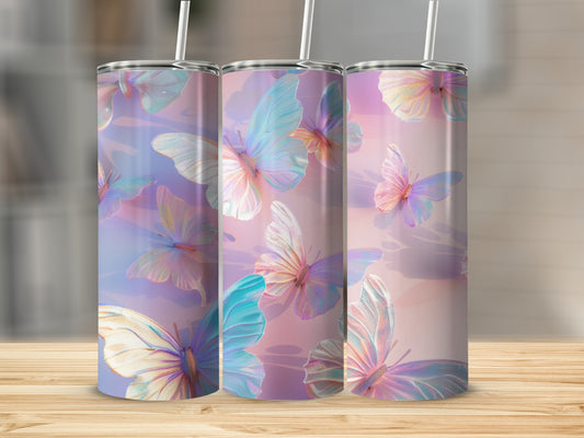 Three tumblers with iridescent butterfly designs on a wooden surface.