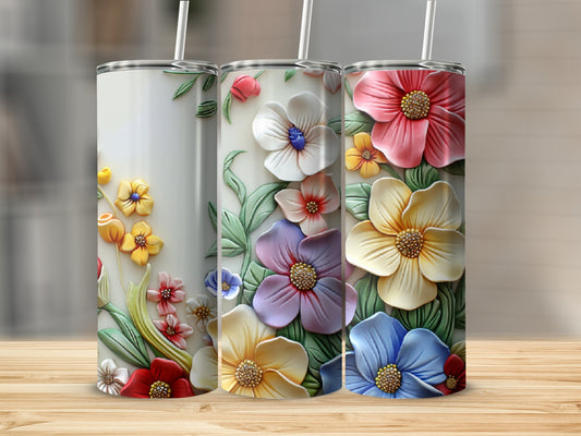 Three floral-patterned tumblers with raised, colorful flowers and leaves.