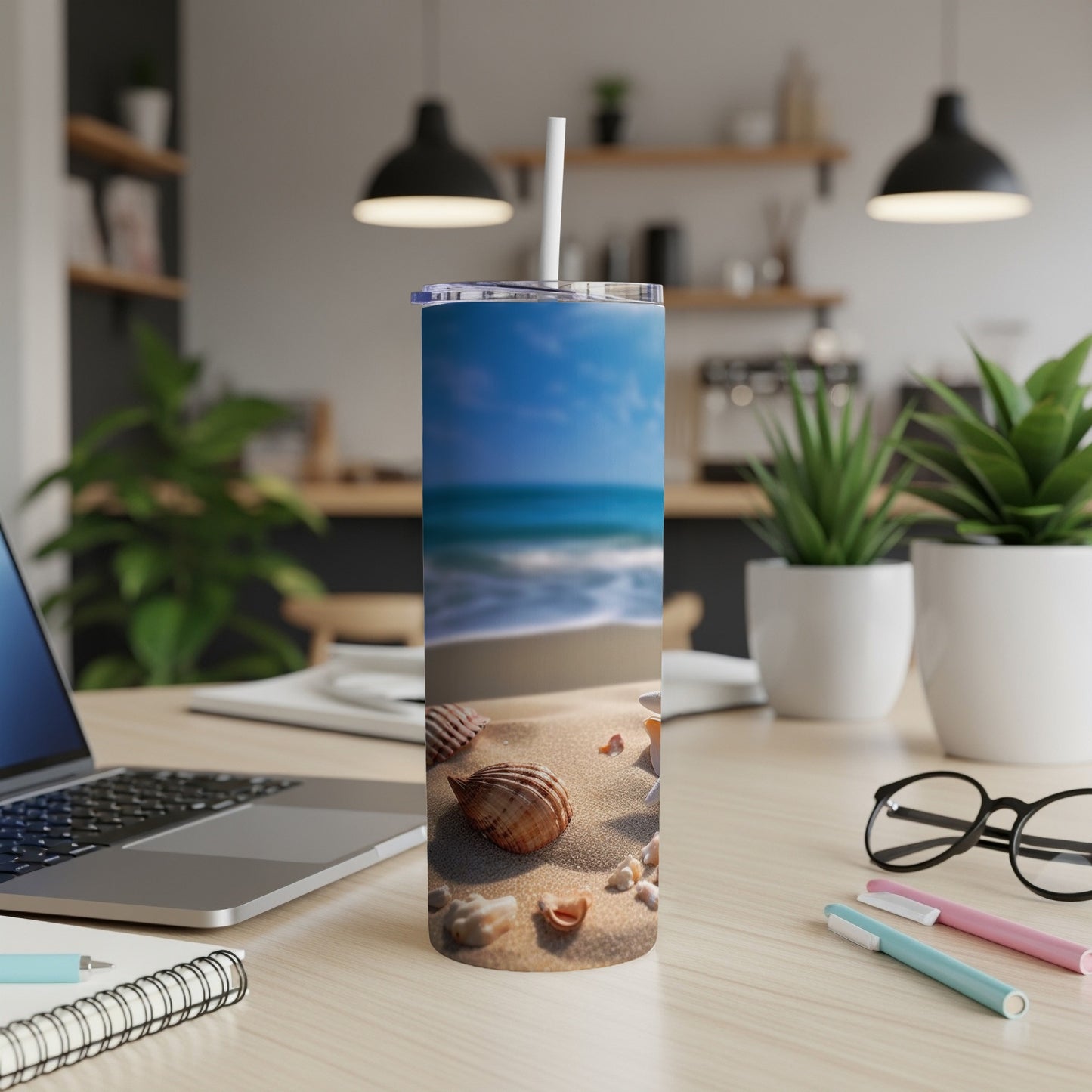 Beach scene with seashells on a blue-tinted tumbler with a straw.