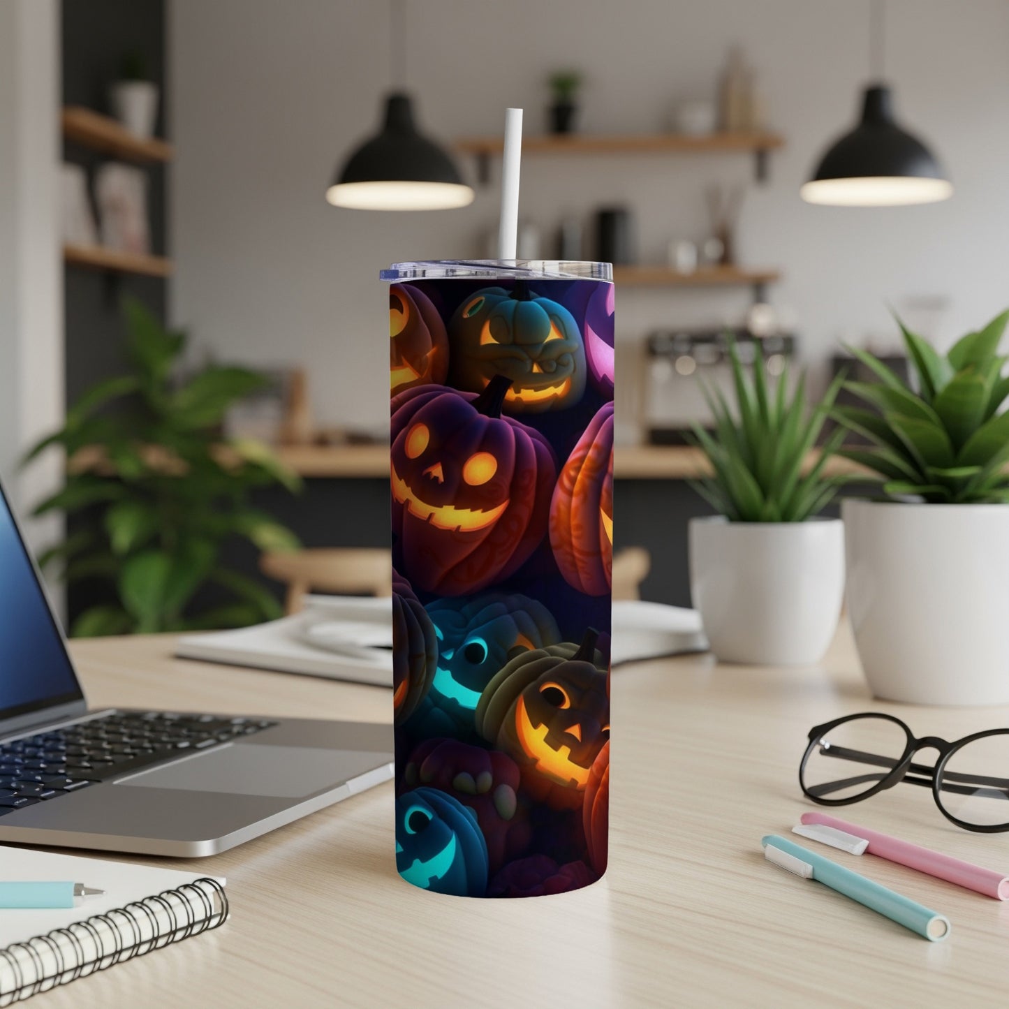 Tumbler with glowing jack-o'-lantern Halloween pattern and white straw.