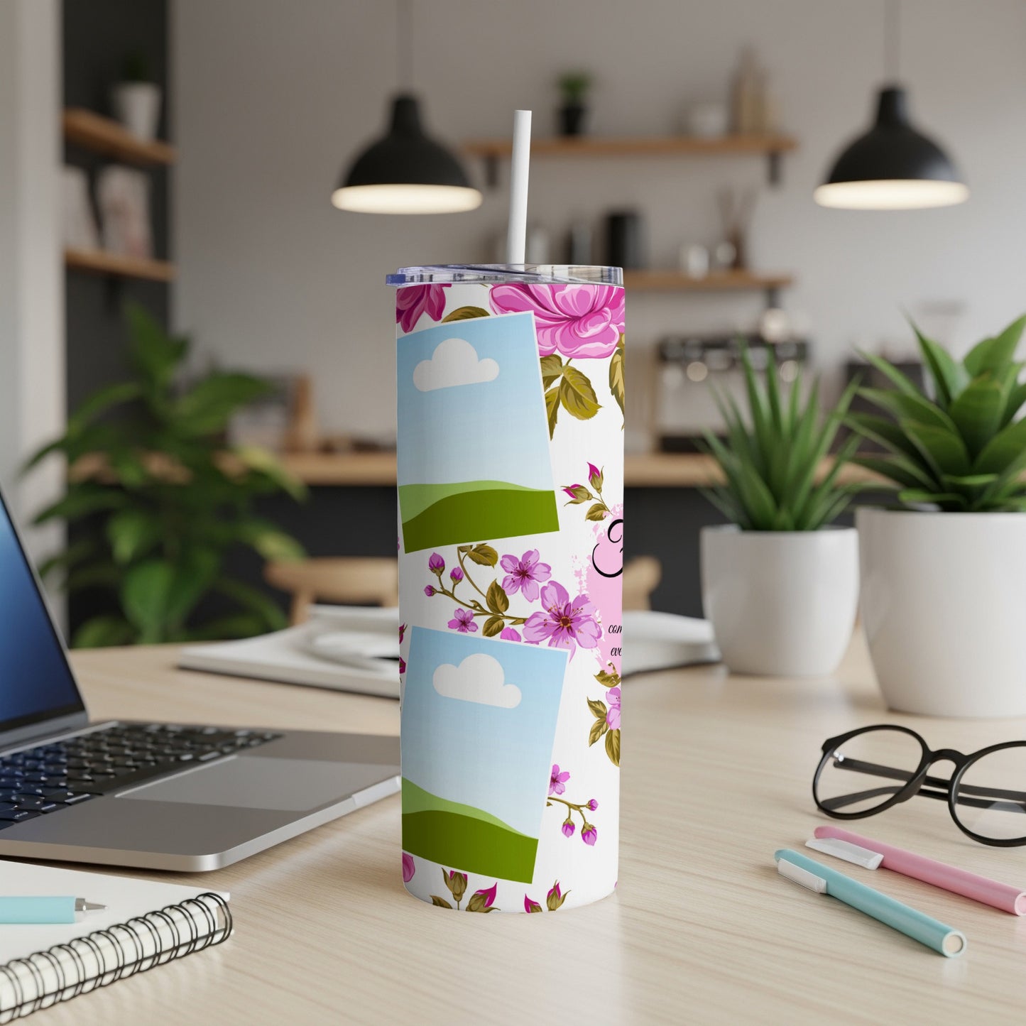 White tumbler with pink floral pattern and stacked photo frames.