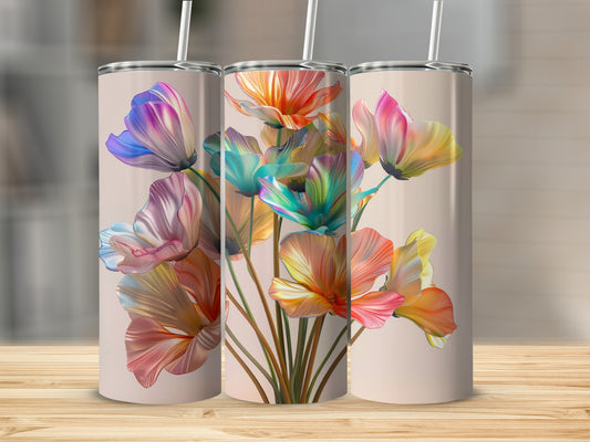 Three tumblers with colorful floral art displayed on a wooden surface.