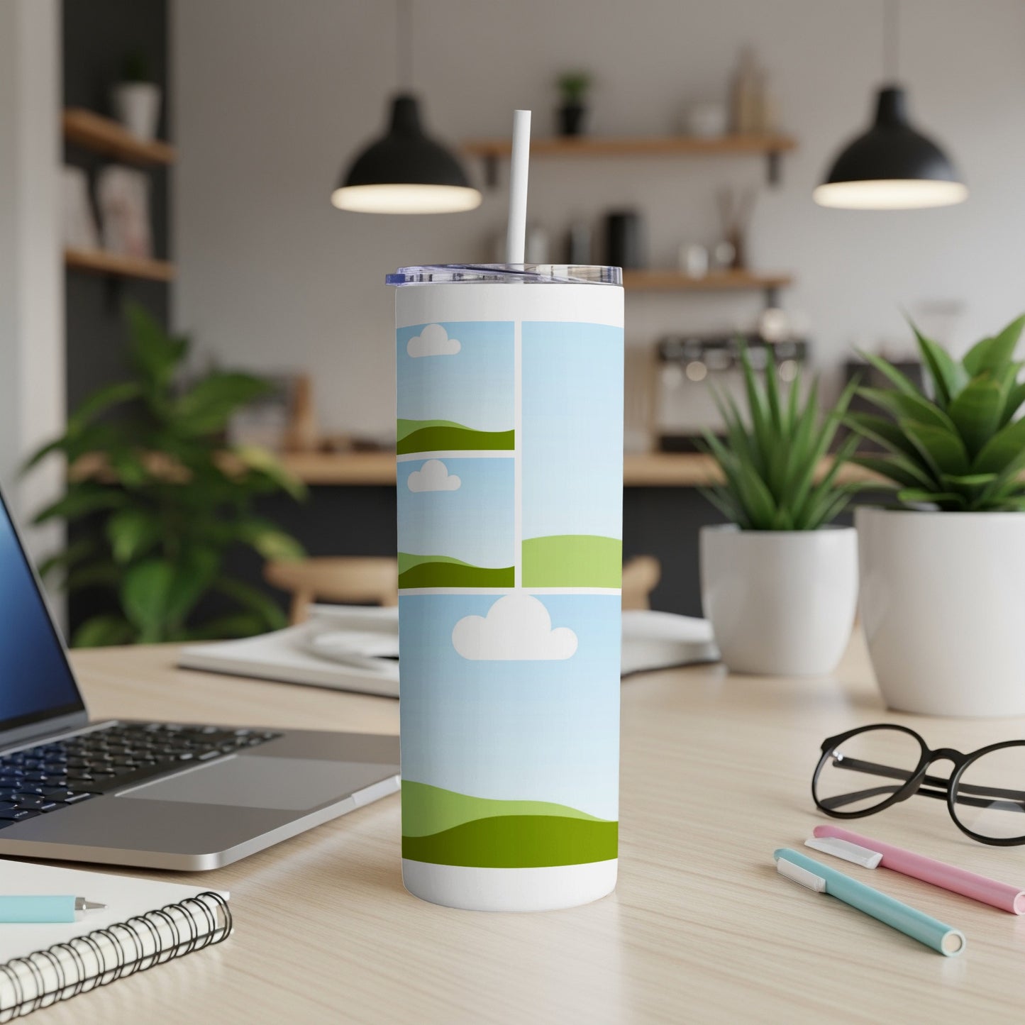 White tumbler with a collage of rolling green hills and sky with clouds.