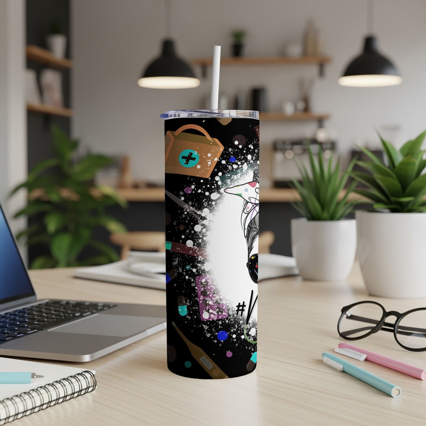 White tumbler with colorful medical icons, stethoscope, and syringe on a dark background.
