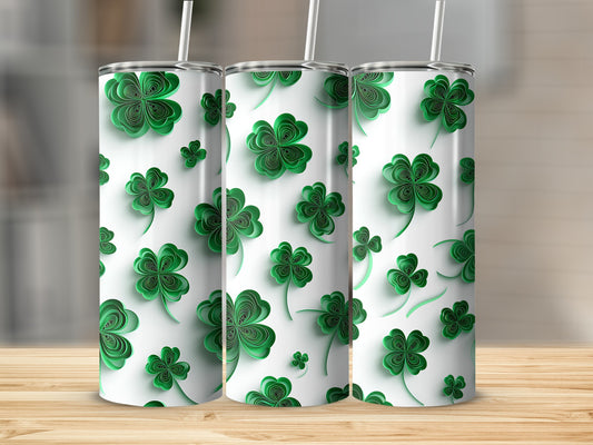 Three tumblers with a repeating green shamrock pattern and white straws.