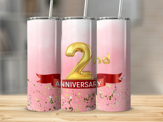 Pink tumbler with "2nd ANNIVERSARY" text and gold confetti accents.