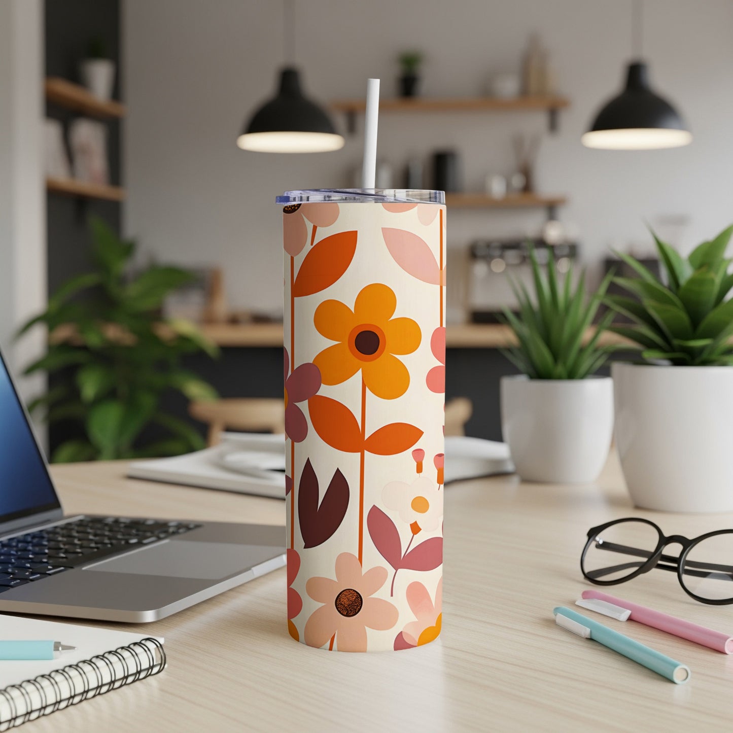 Tall insulated tumbler with a retro floral pattern and a straw.