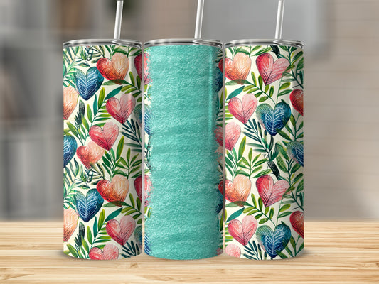 Tall tumbler with a floral and heart pattern and a textured aqua middle.