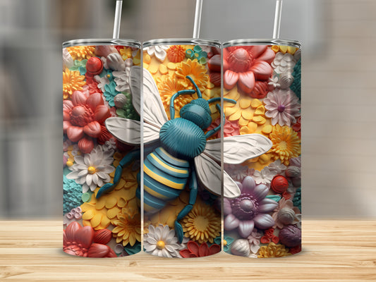 Three tumblers with a bee and floral design on a wooden surface.