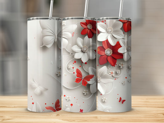 Three stainless steel tumblers with white and red flowers and butterflies.