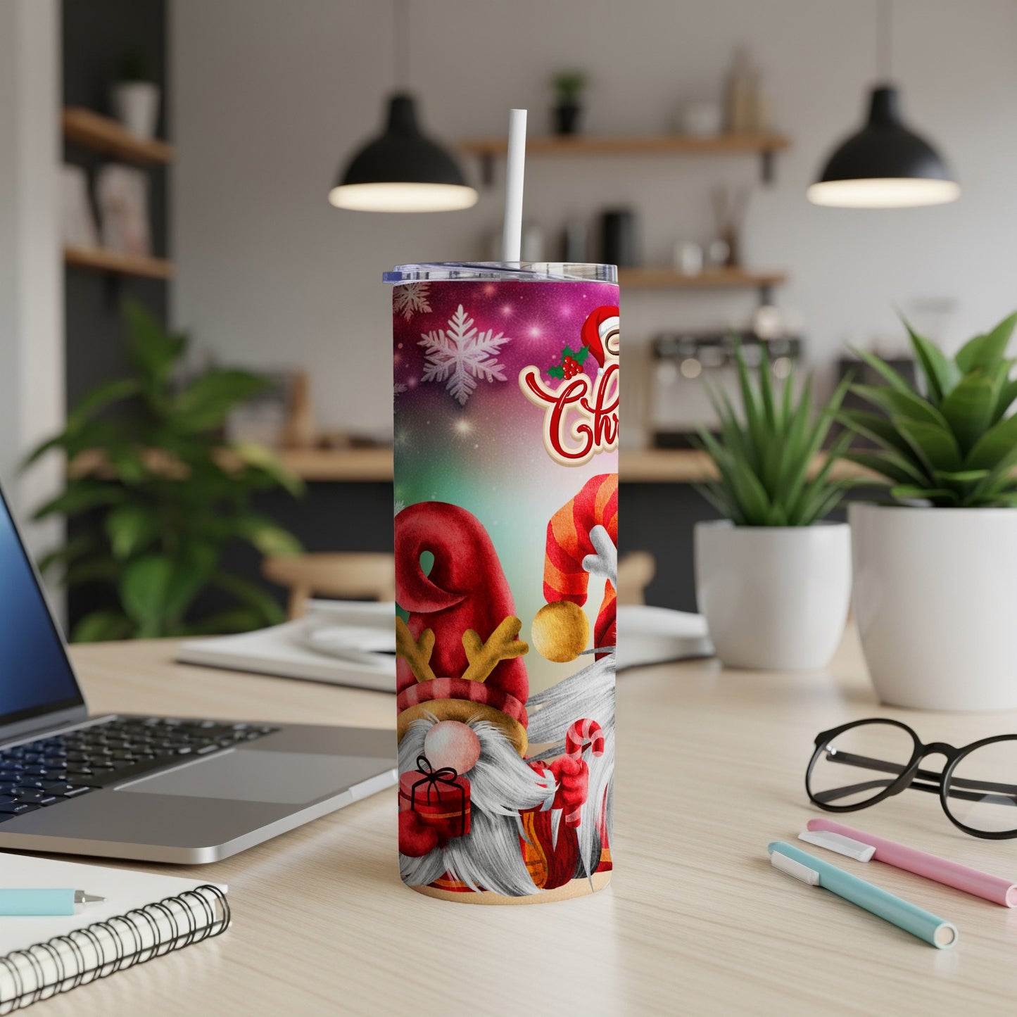 Christmas gnomes with gifts on a festive tumbler, on a desk.