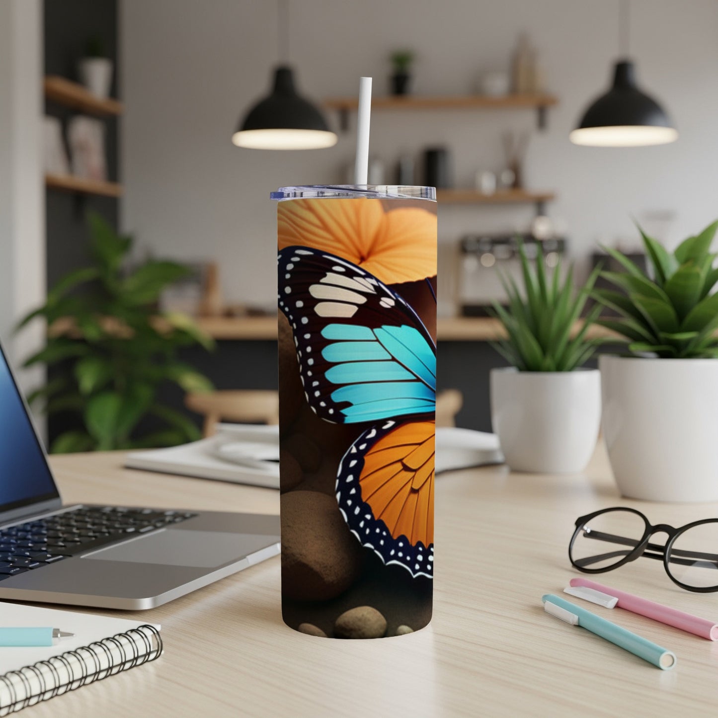 Tumbler with a close-up of a butterfly and orange flower.