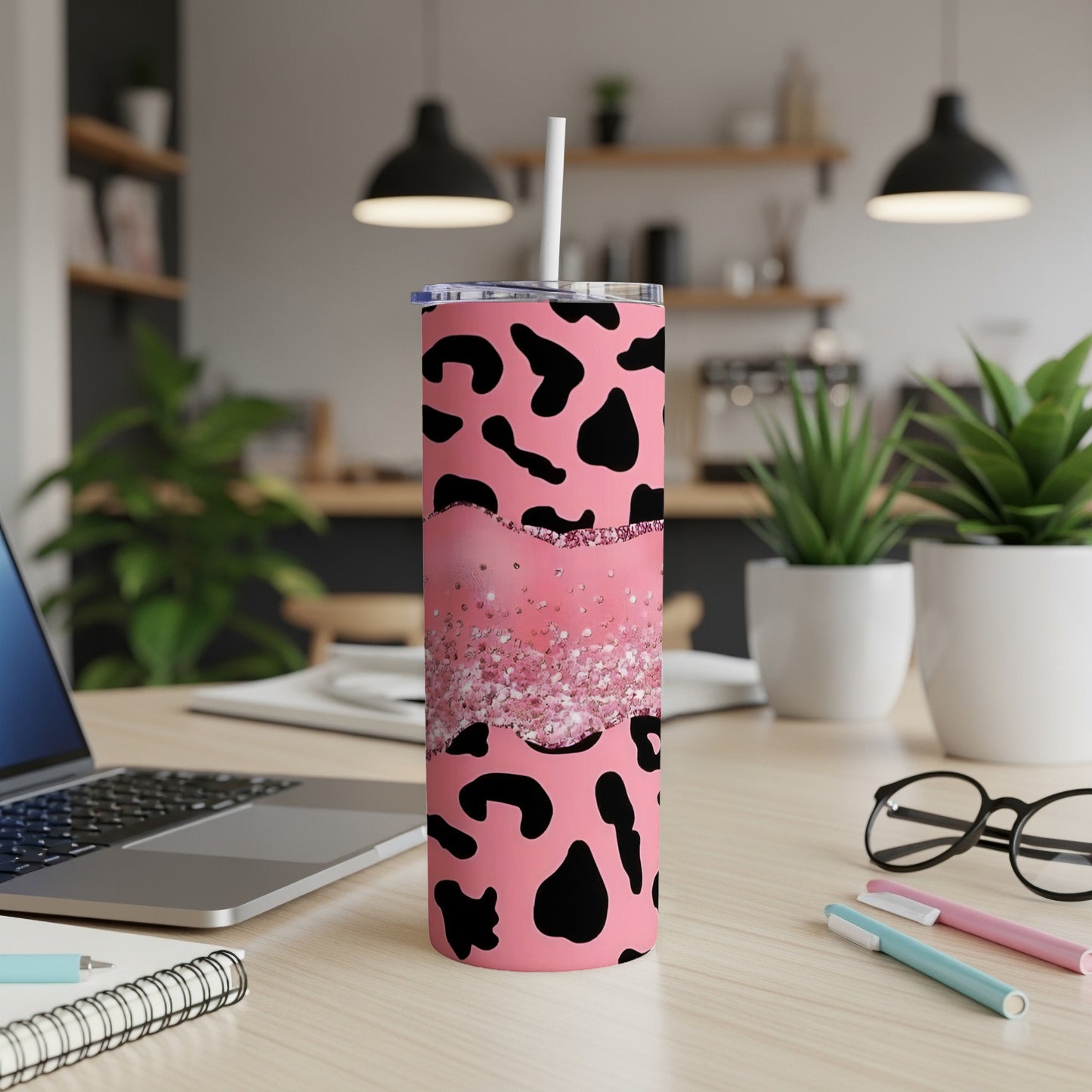 Pink tumbler with black cow spots and glitter design.