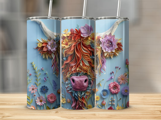 Floral highland cow illustration on three blue tumblers.