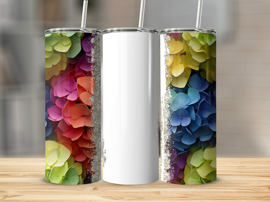 Three tumblers with colorful floral patterns and glitter accents.