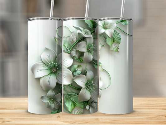 Three white tumblers with delicate green floral designs on a wooden surface.