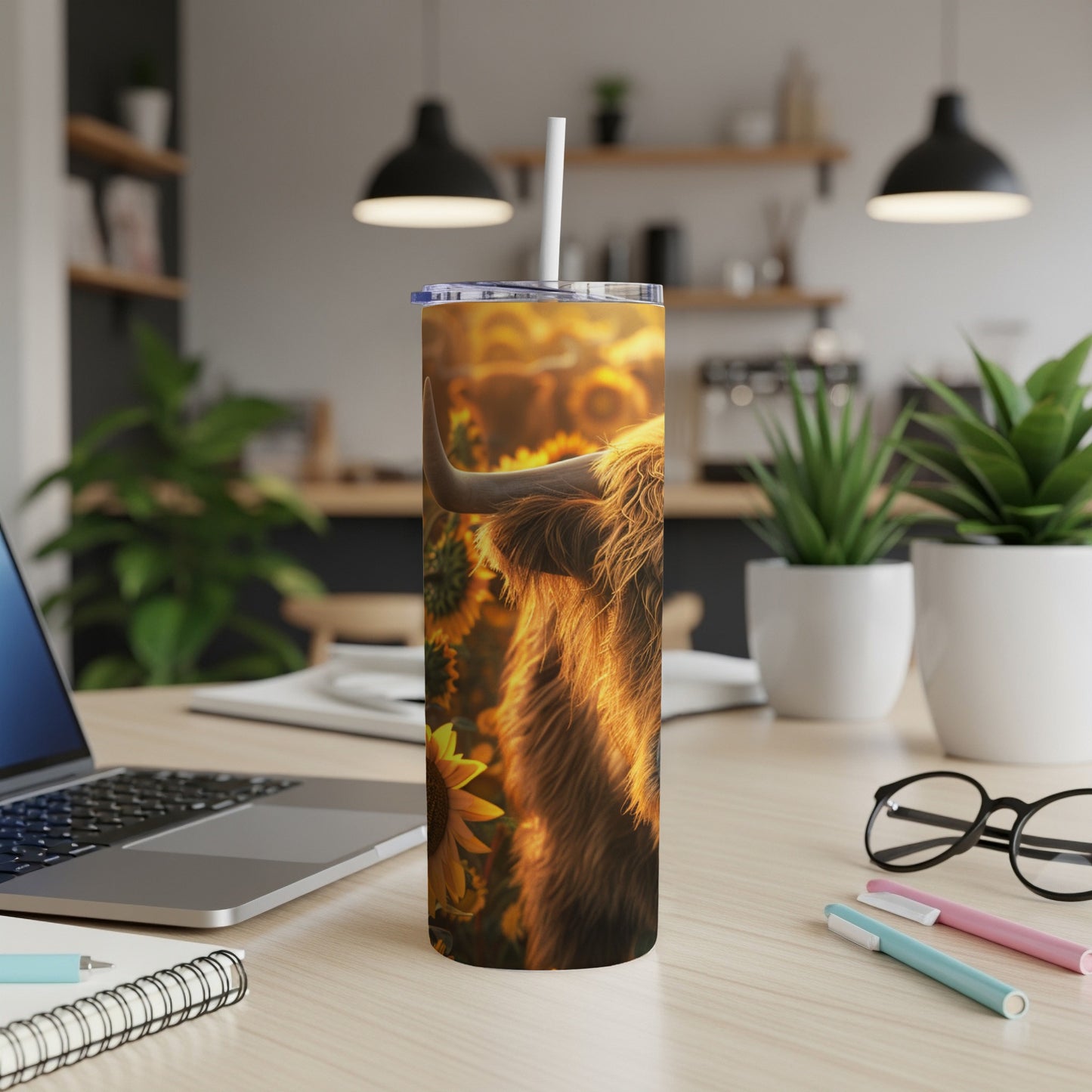 Highland cow with sunflowers on a stainless steel tumbler.