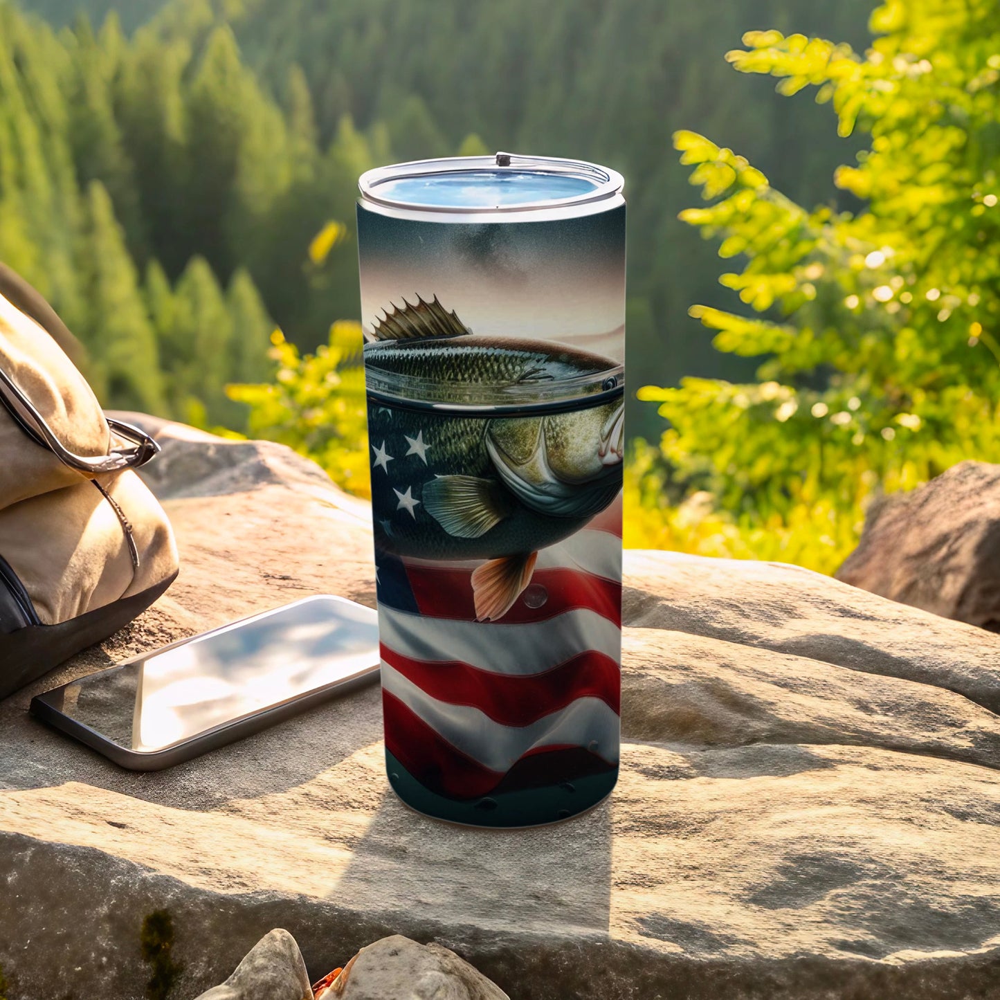 Bass jumping over American flag on a tumbler next to a phone and bag.