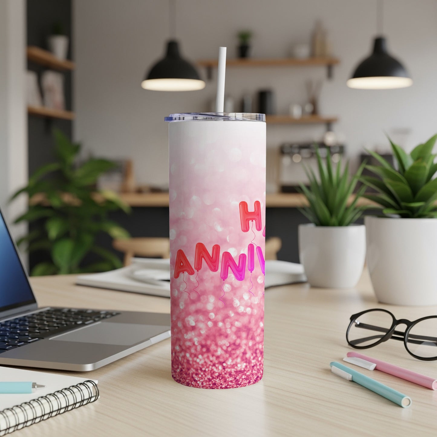 Glittery pink tumbler with "Happy Anniversary" balloons and text.