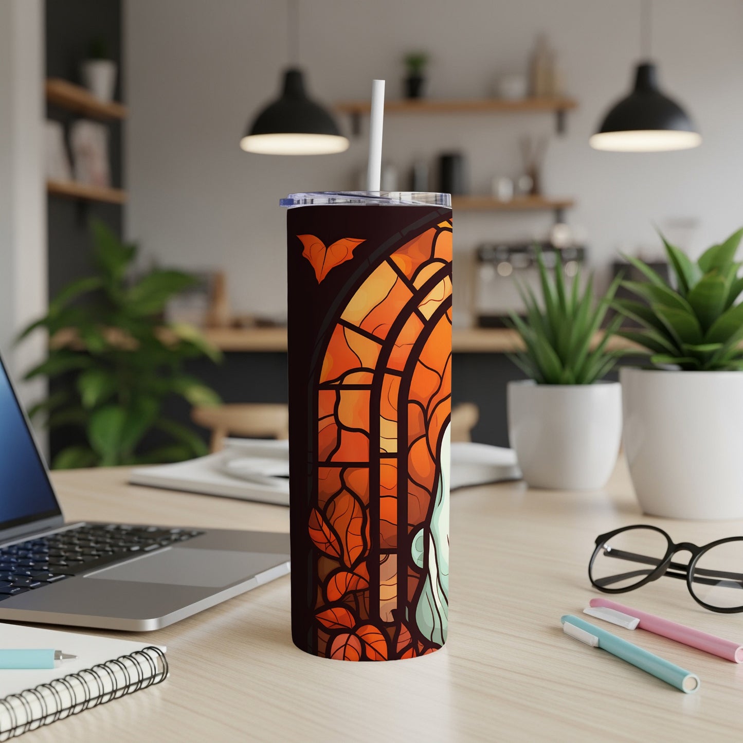 Stained glass tumbler with a ghost, bats, and autumn leaves.