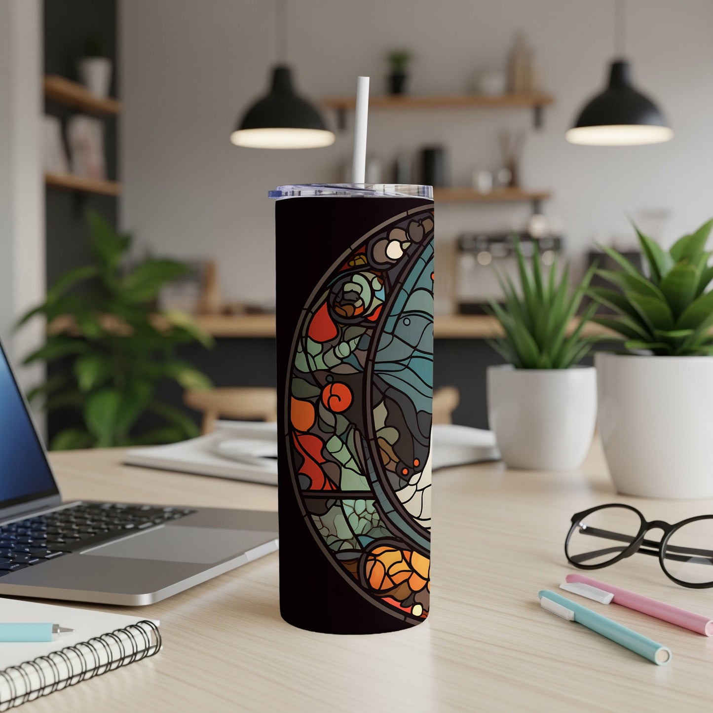 Stained glass celestial moon design on a black tumbler with a white straw.