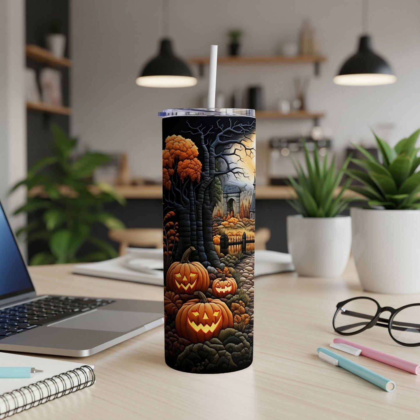 Tumbler with a spooky Halloween scene featuring pumpkins and a haunted forest.