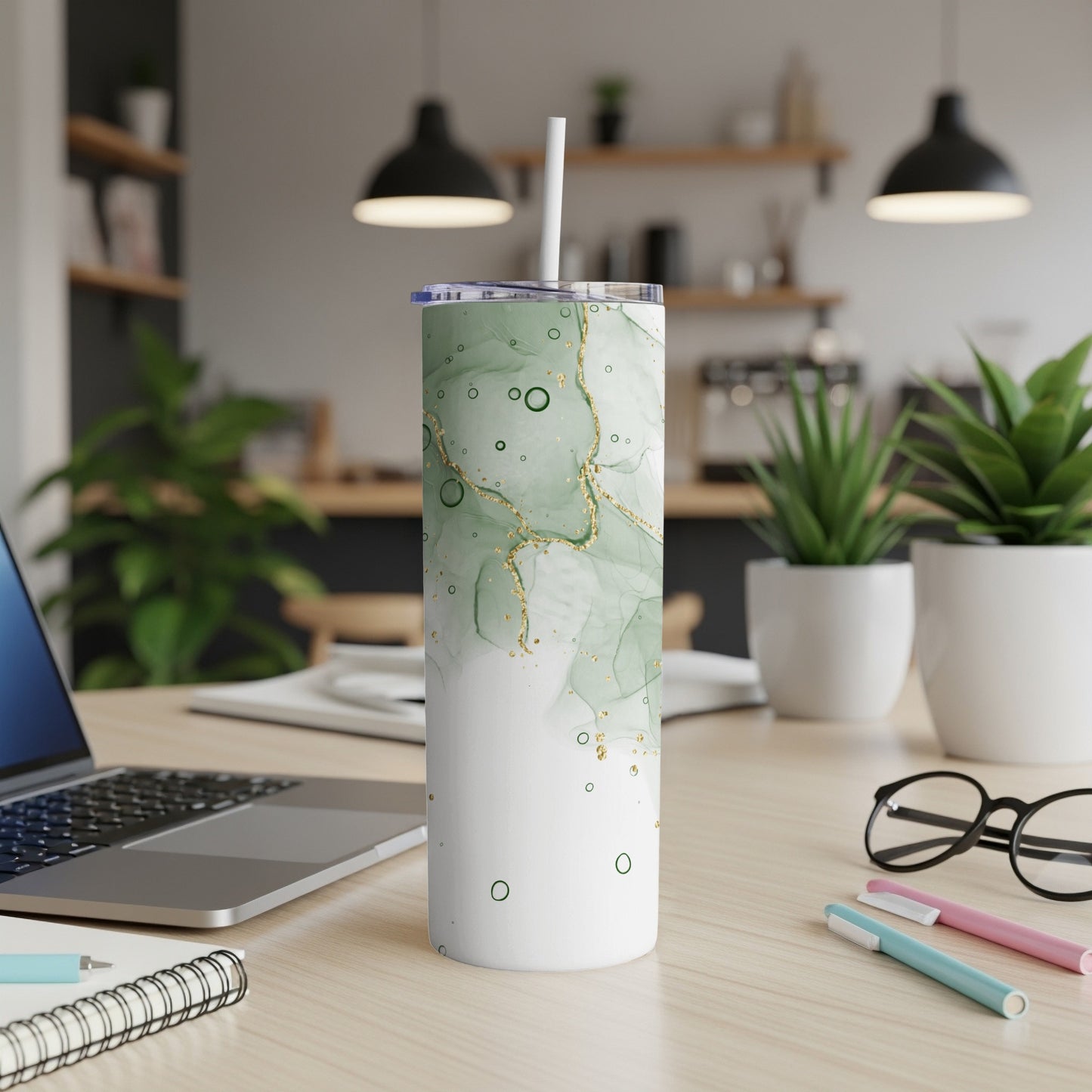 Green and white marble pattern tumbler with gold accents and straw.