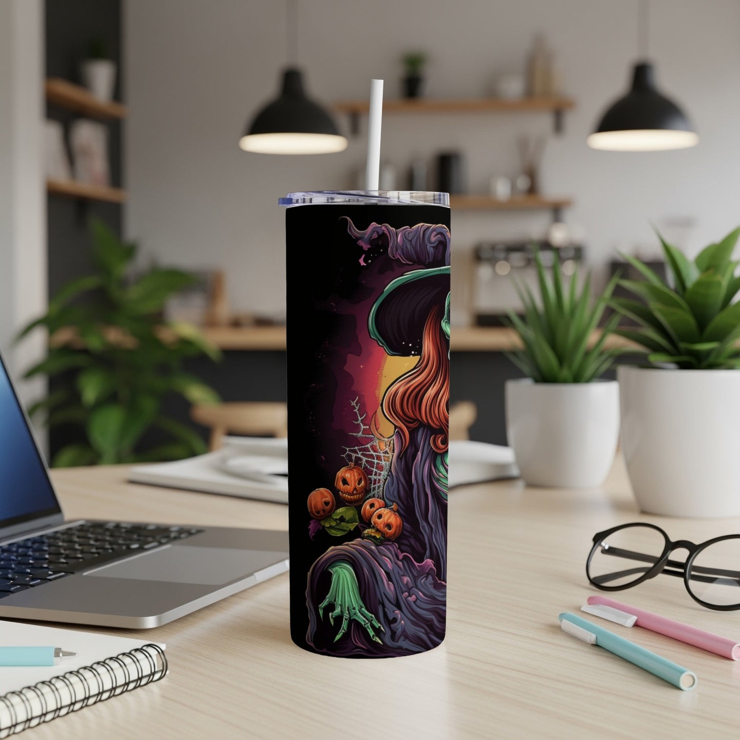 Black tumbler with witch, pumpkins, and spiderweb Halloween illustration.