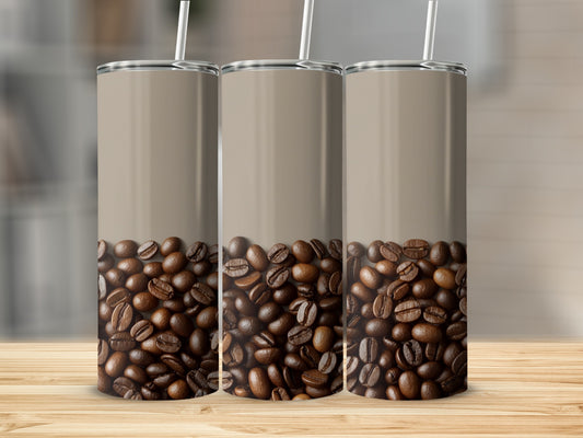 Three tumblers with coffee beans at the bottom, on a wooden surface.