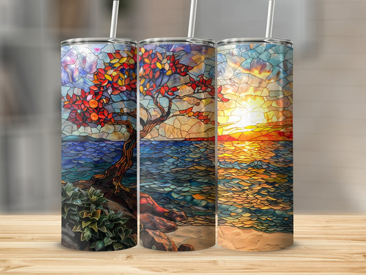 Three tumblers with stained glass art of a tree, ocean, and sunset.