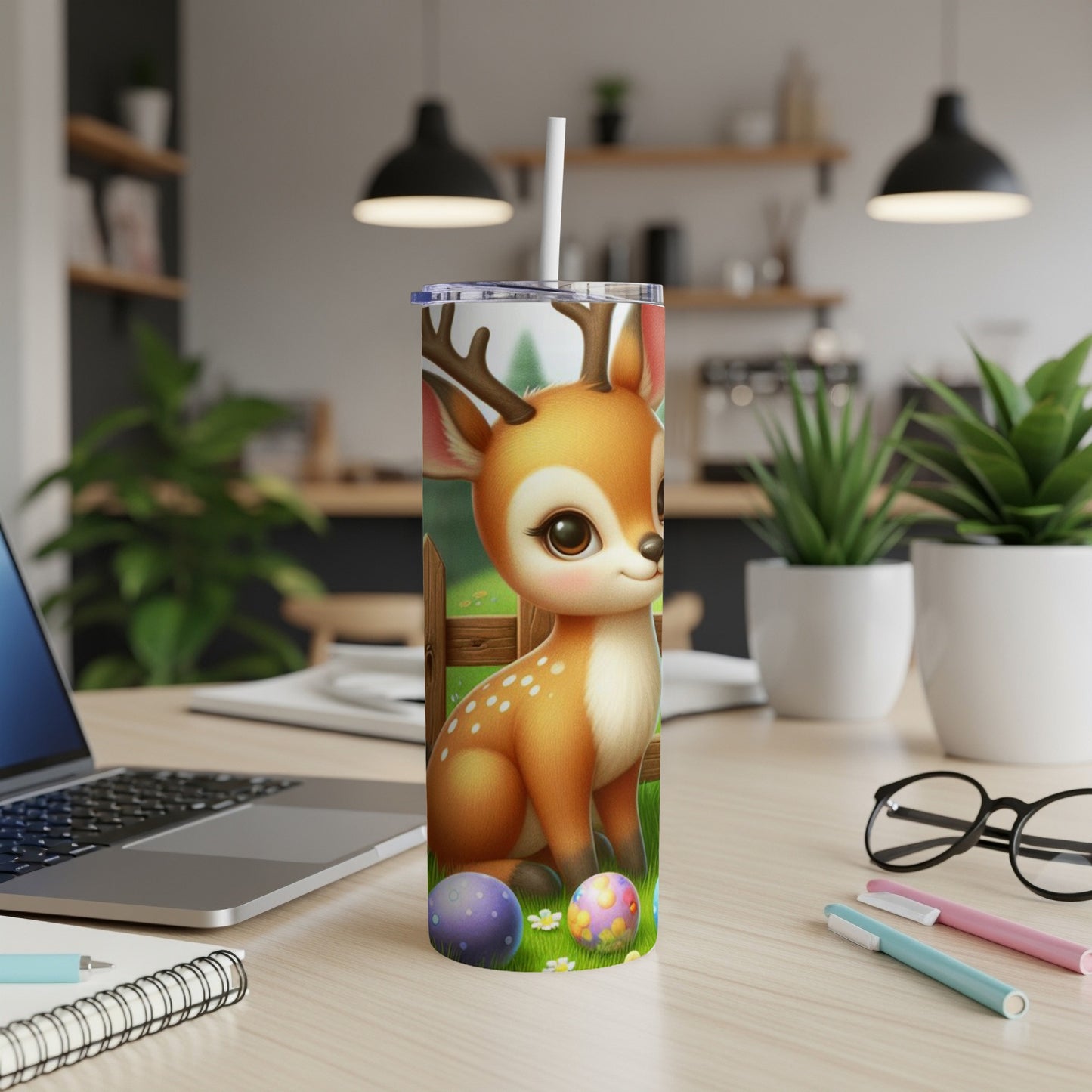 Cute cartoon deer with Easter eggs on a desk with a laptop.