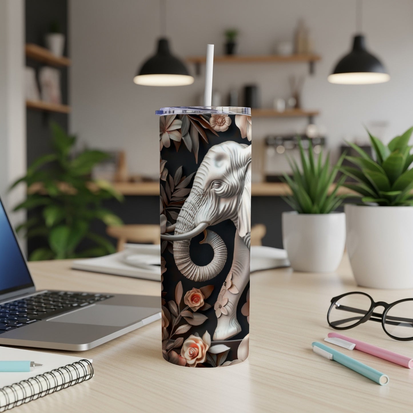 White elephant and floral design on black skinny tumbler with straw.