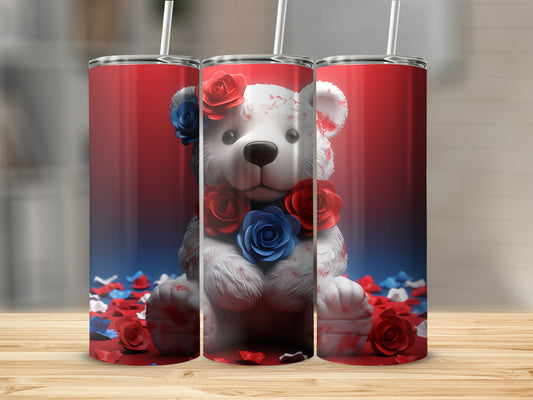 Teddy bear adorned with red and blue roses on a patriotic tumbler.