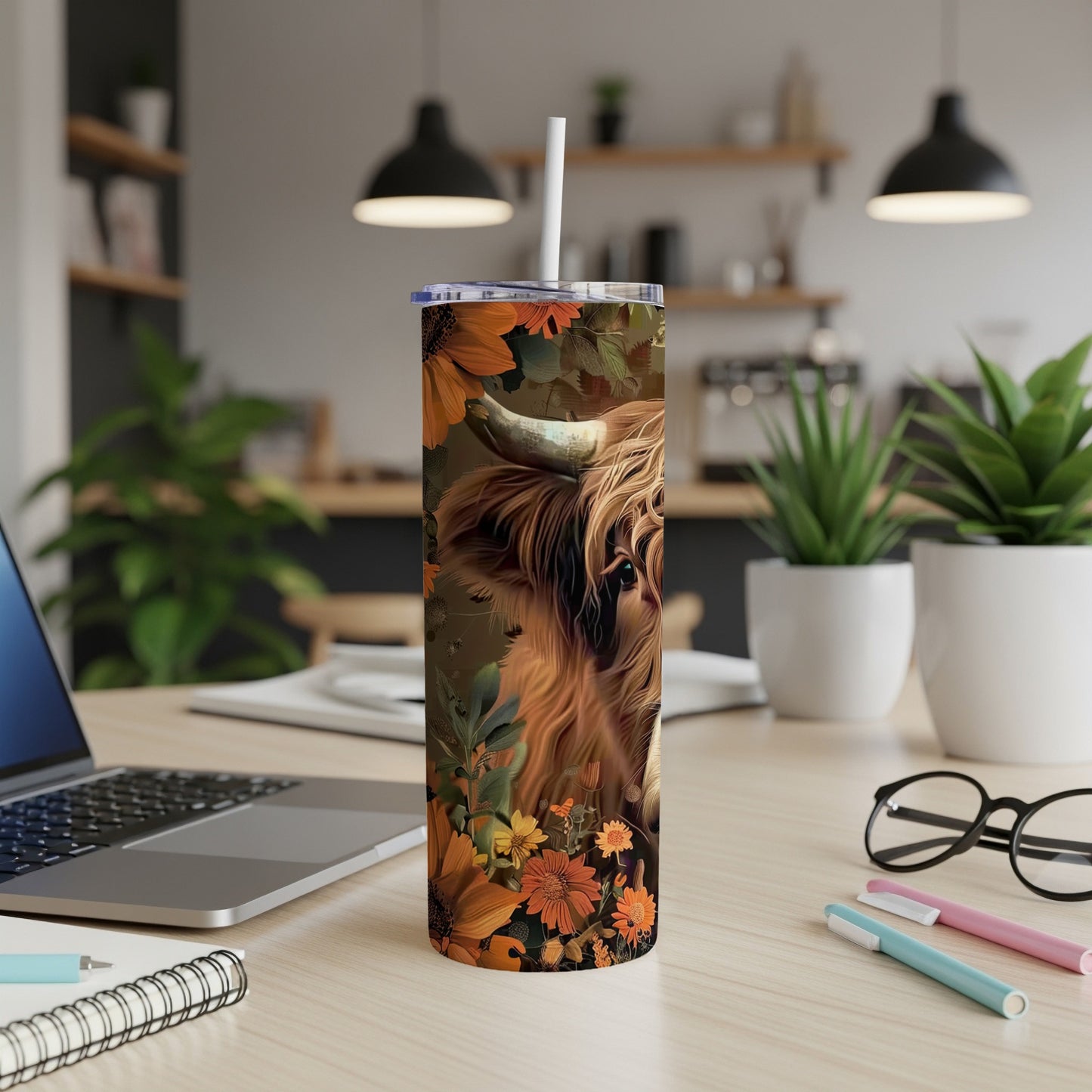 Highland cow with sunflowers and leaves on a skinny tumbler.