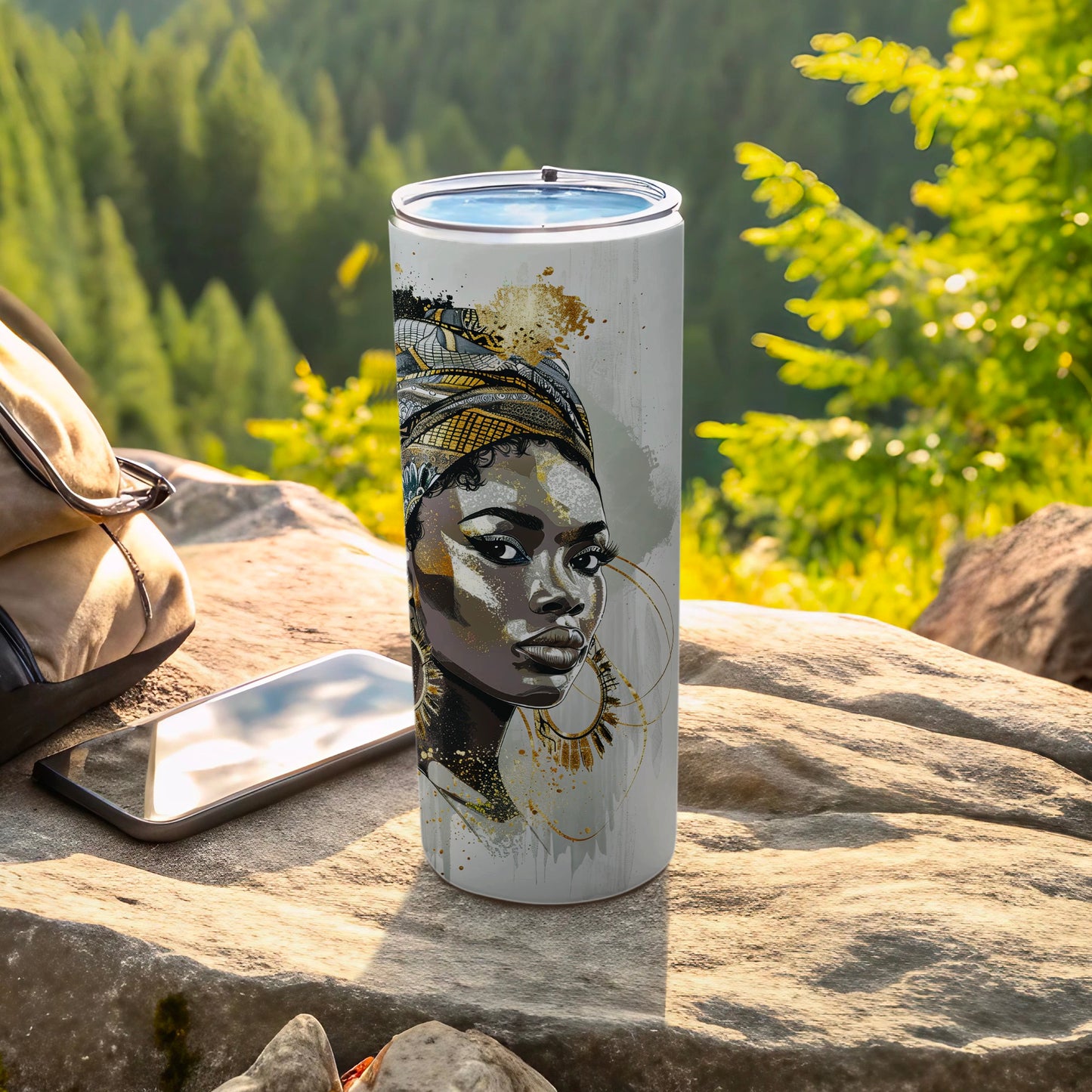 Tumbler with a gold and black portrait of a woman with African-inspired headdress.