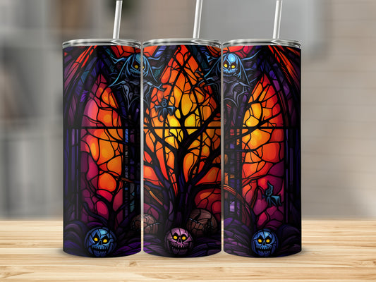 Three tumblers with a stained-glass Halloween design featuring spooky figures and pumpkins.