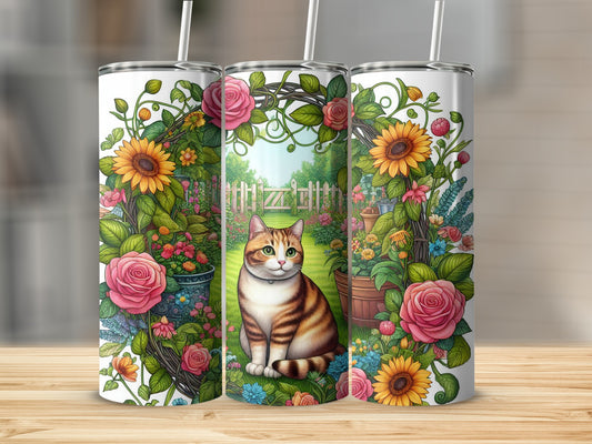 Tabby cat among sunflowers and roses in a garden on a tumbler.