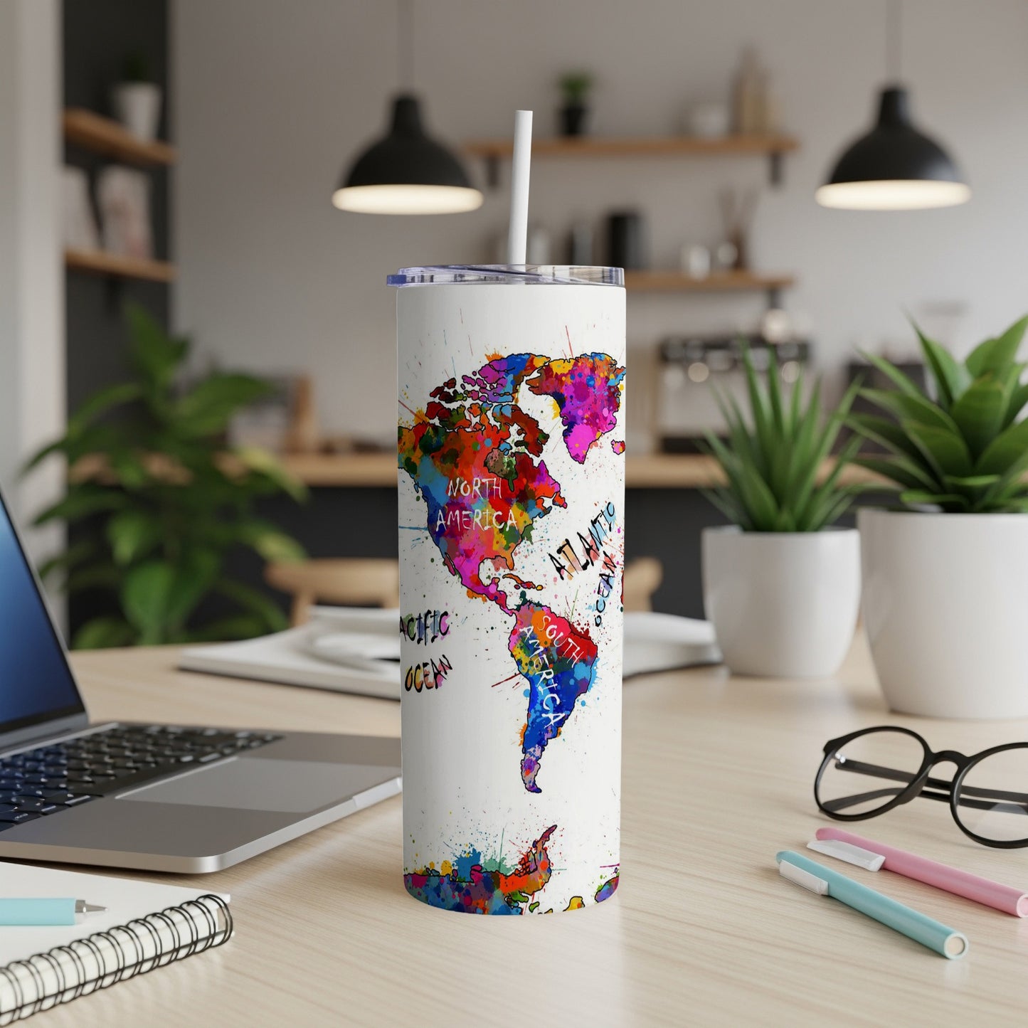 White tumbler with colorful watercolor map of the world and ocean names.