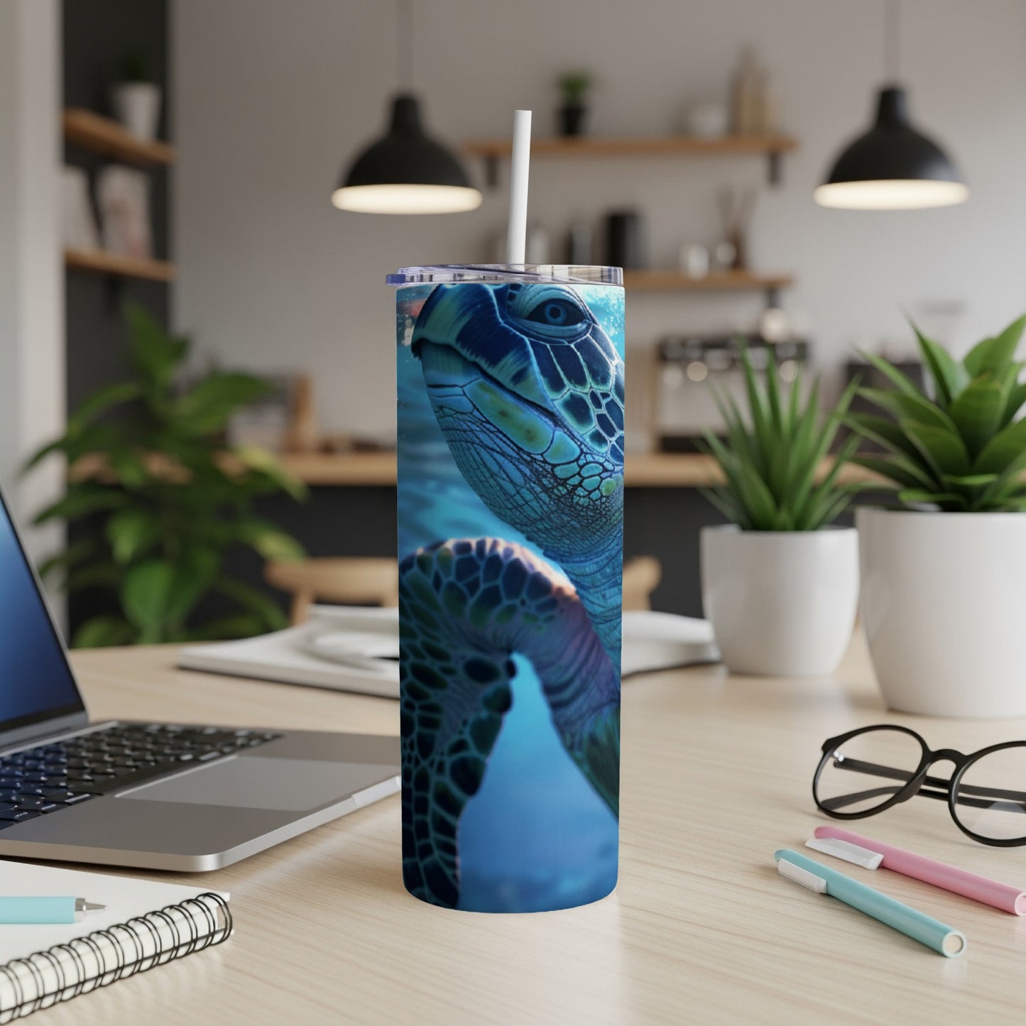 Close-up of a sea turtle on a blue speckled tumbler with a straw.