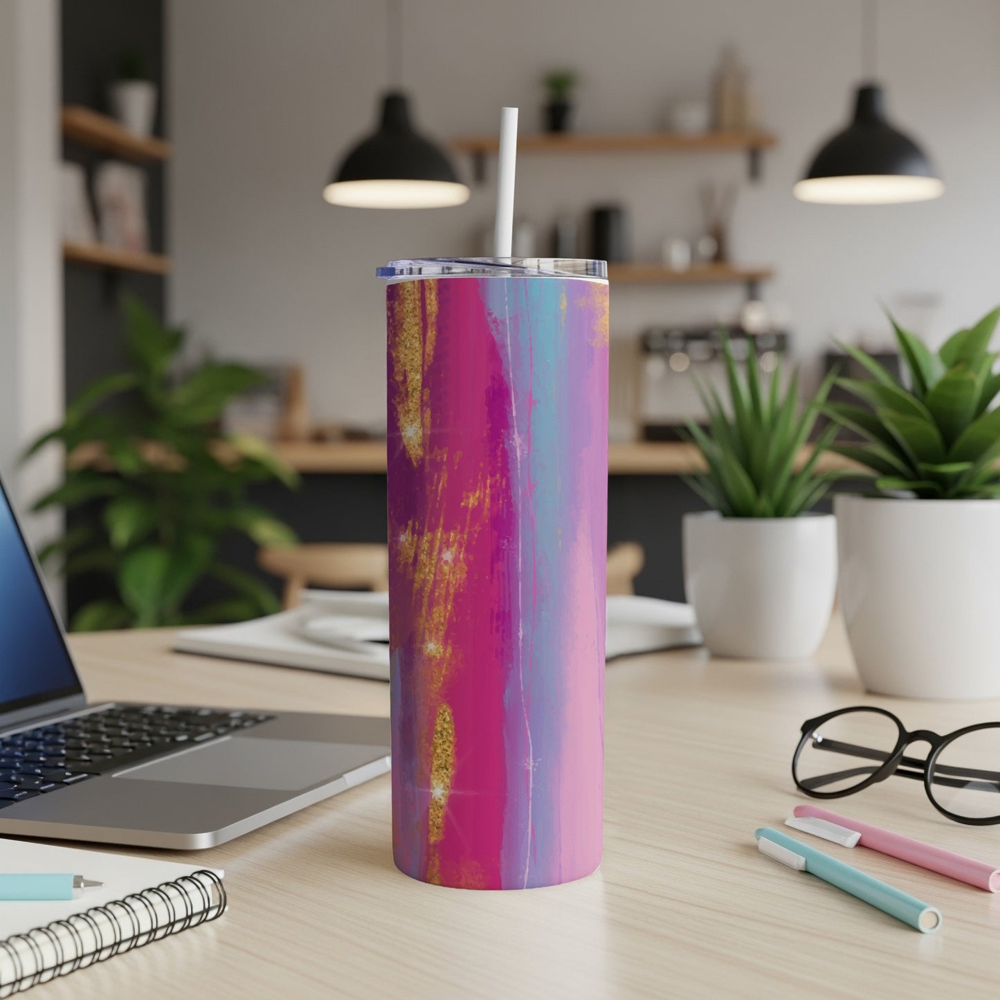 Tumbler with abstract pink, blue, and gold brushstroke design and white straw.