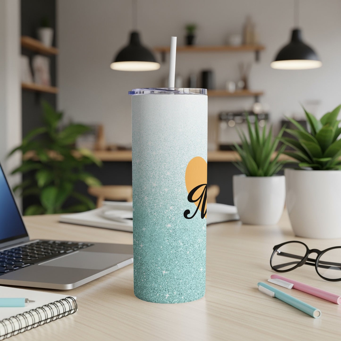 White tumbler with blue glitter gradient and orange heart with "M" script.
