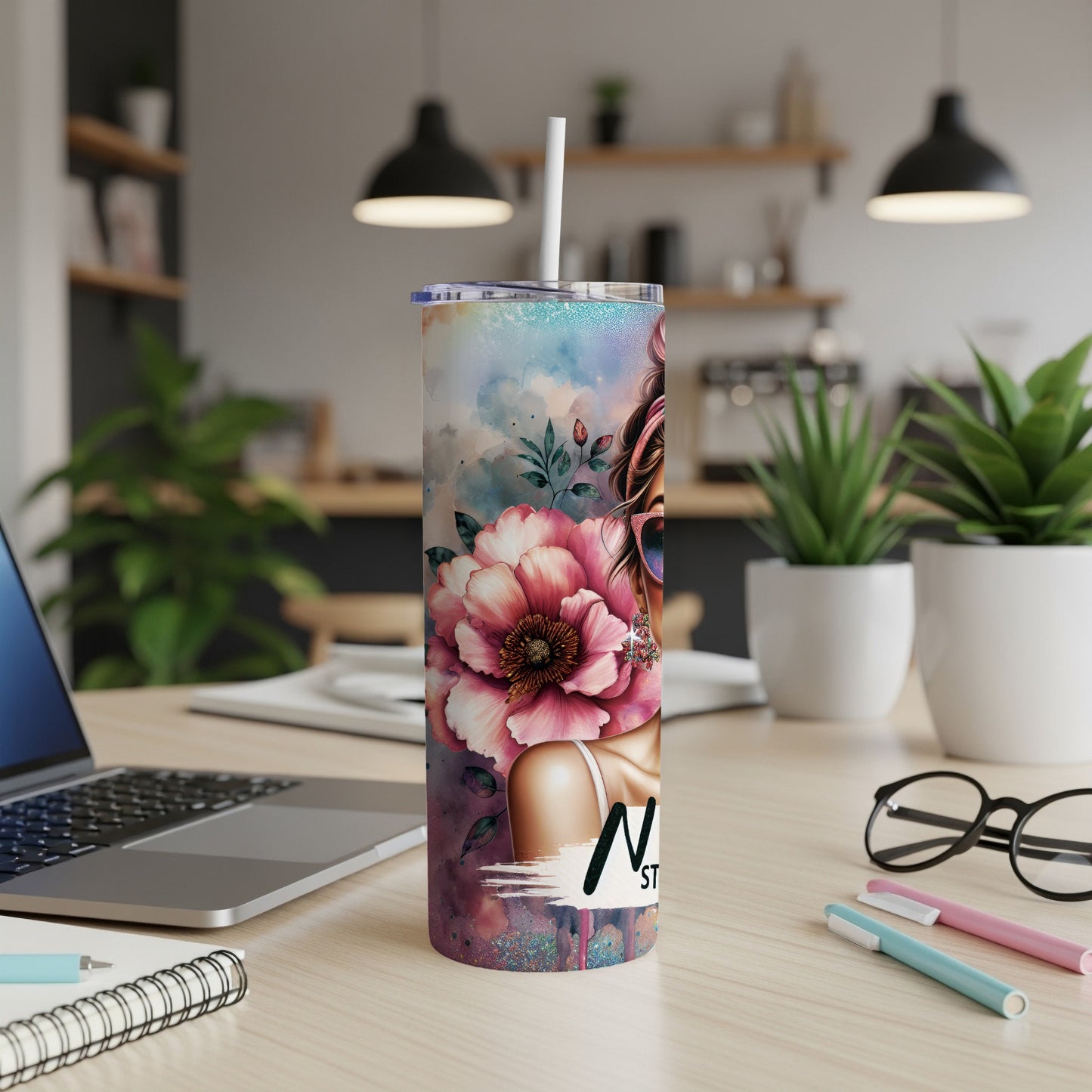 Tumbler with watercolor floral art and a woman's profile with "Nailed It!" text.