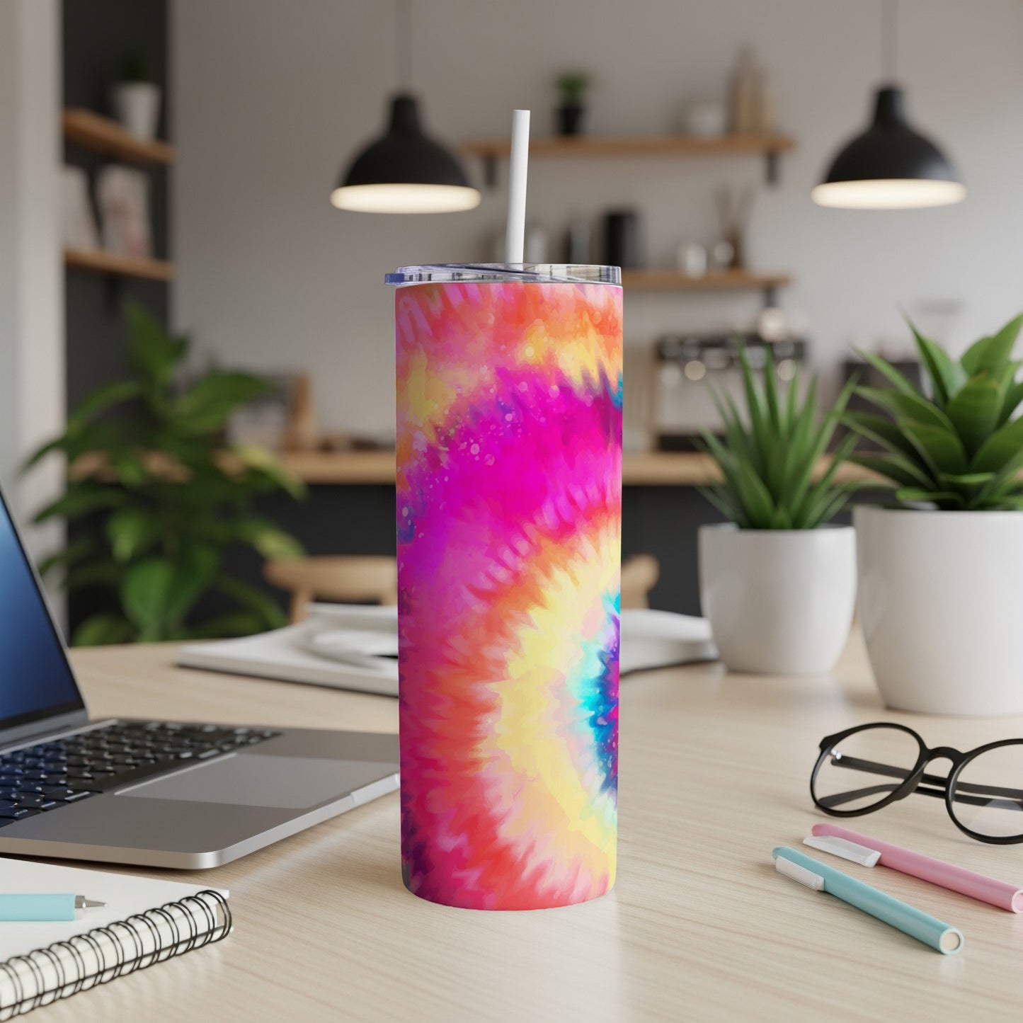 Tall tumbler with colorful tie-dye pattern and white straw.