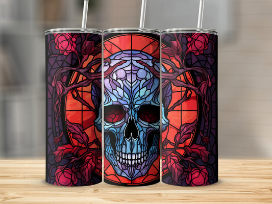 Stained glass skull design with swirling red and purple vines on a tumbler.