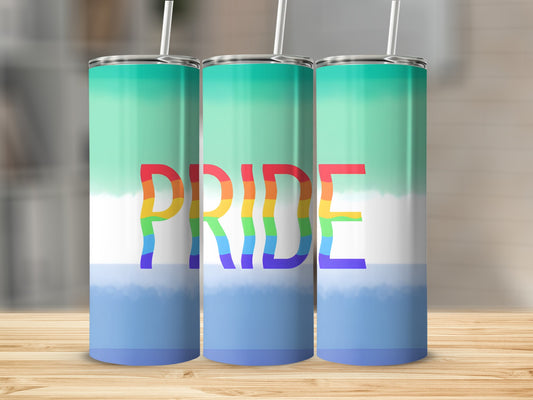 Pride flag tumbler with rainbow text on a wooden surface.