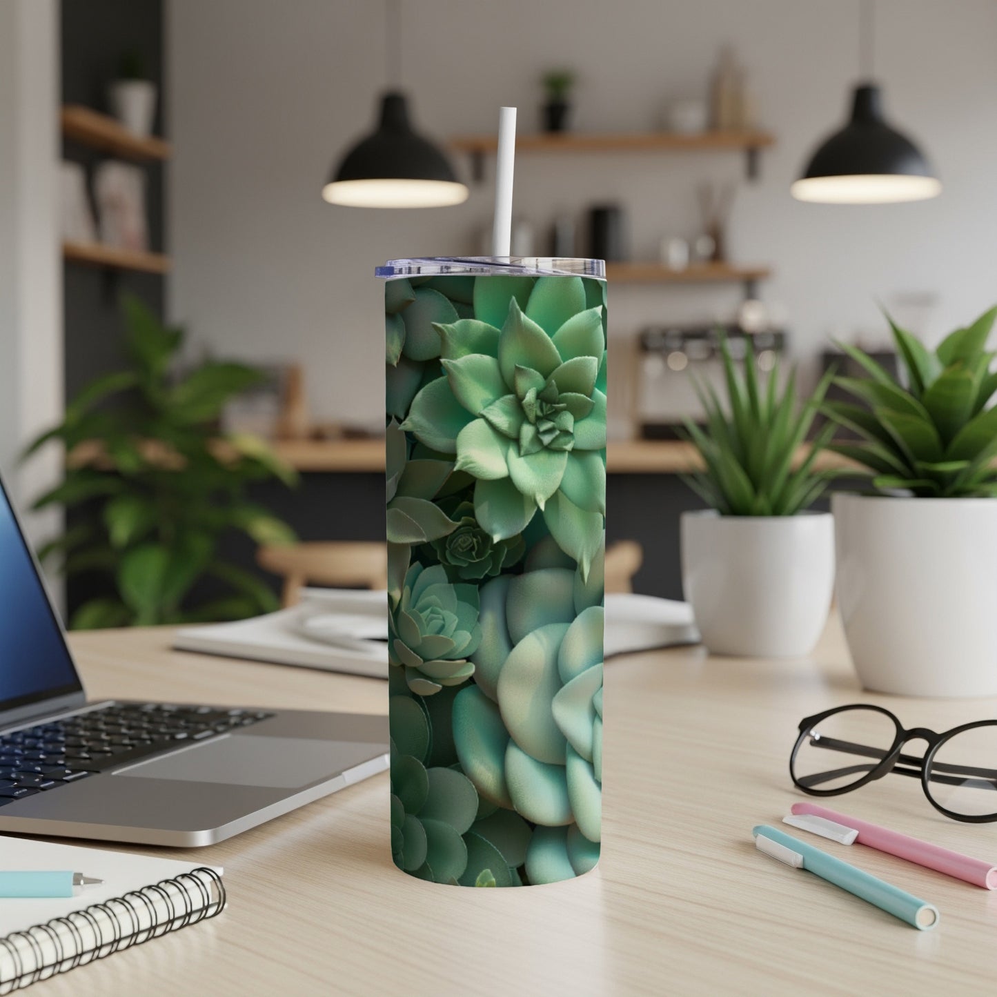 Green succulent pattern on a white skinny tumbler with a straw.