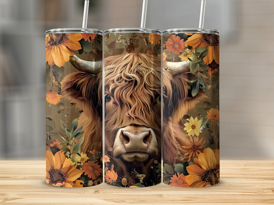 Three tumblers featuring a Highland cow with floral accents and straw lids.