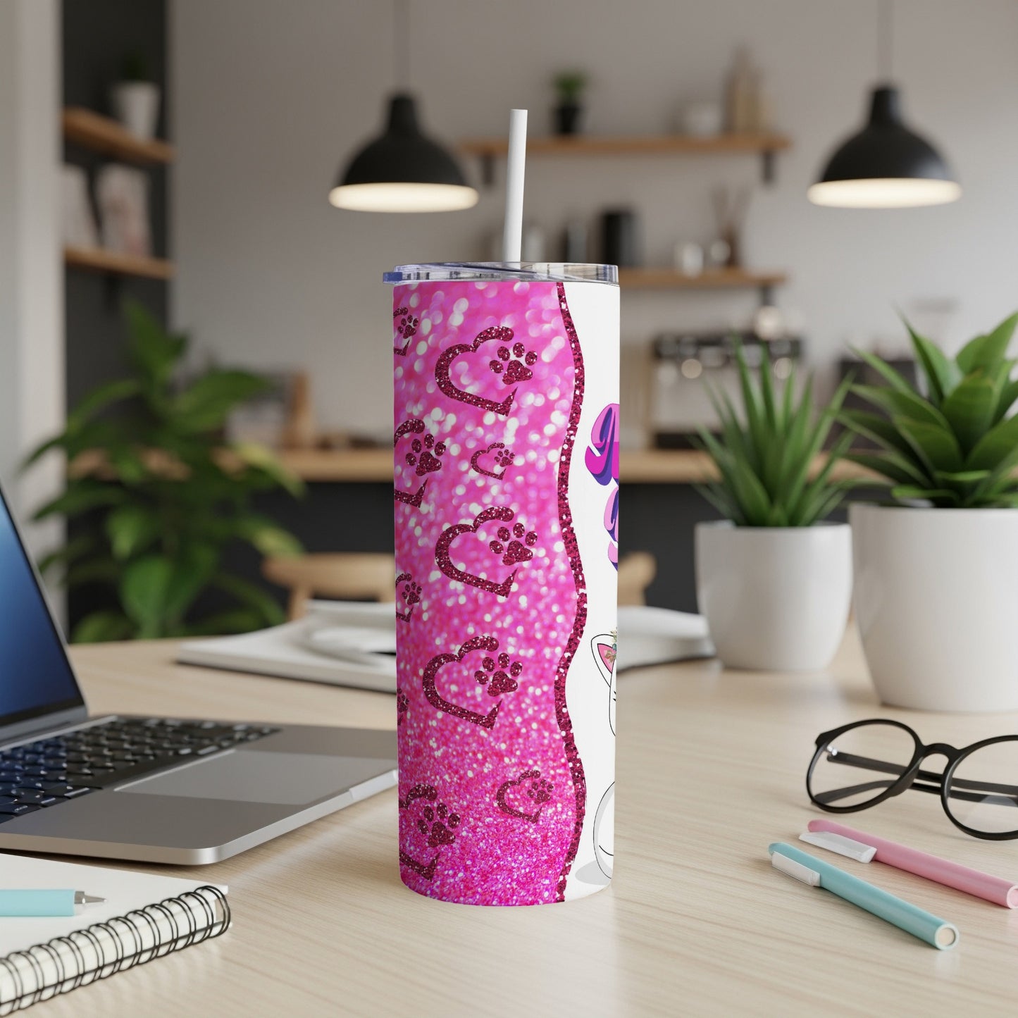 Pink glitter paw print tumbler with white lid and straw.