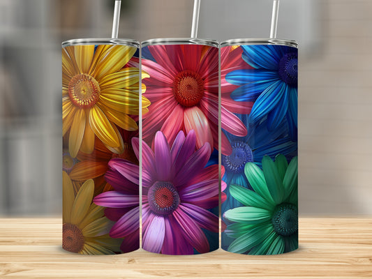 Three tumblers with colorful floral designs in yellow, pink, and blue.